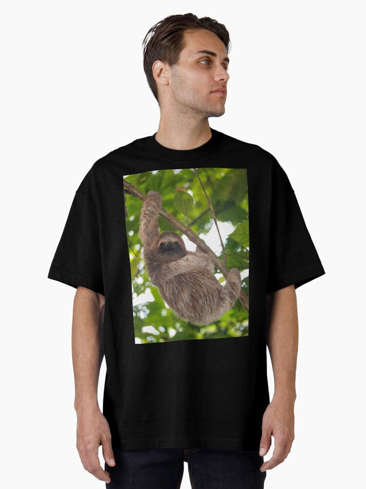 A young three-toed sloth animal in the jungle Oversized T-Shirt