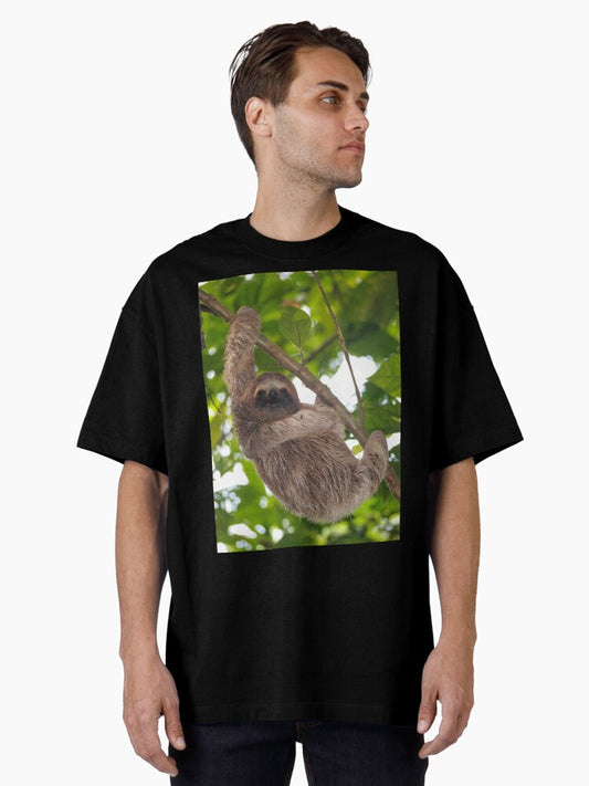 A young three-toed sloth animal in the jungle Oversized T-Shirt