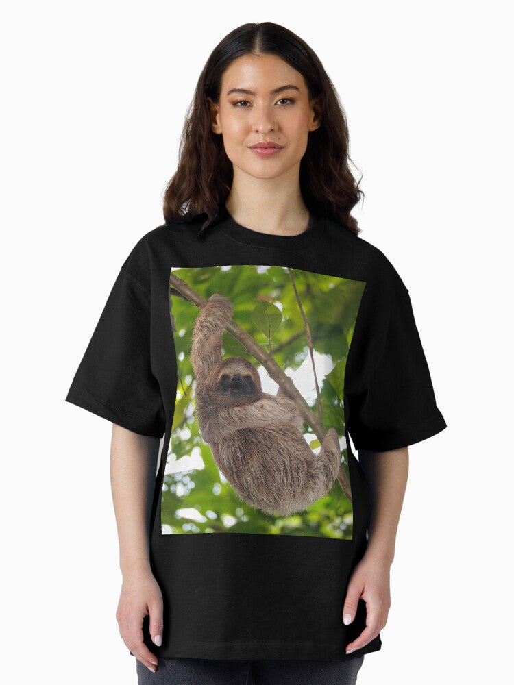 A young three-toed sloth animal in the jungle Oversized T-Shirt